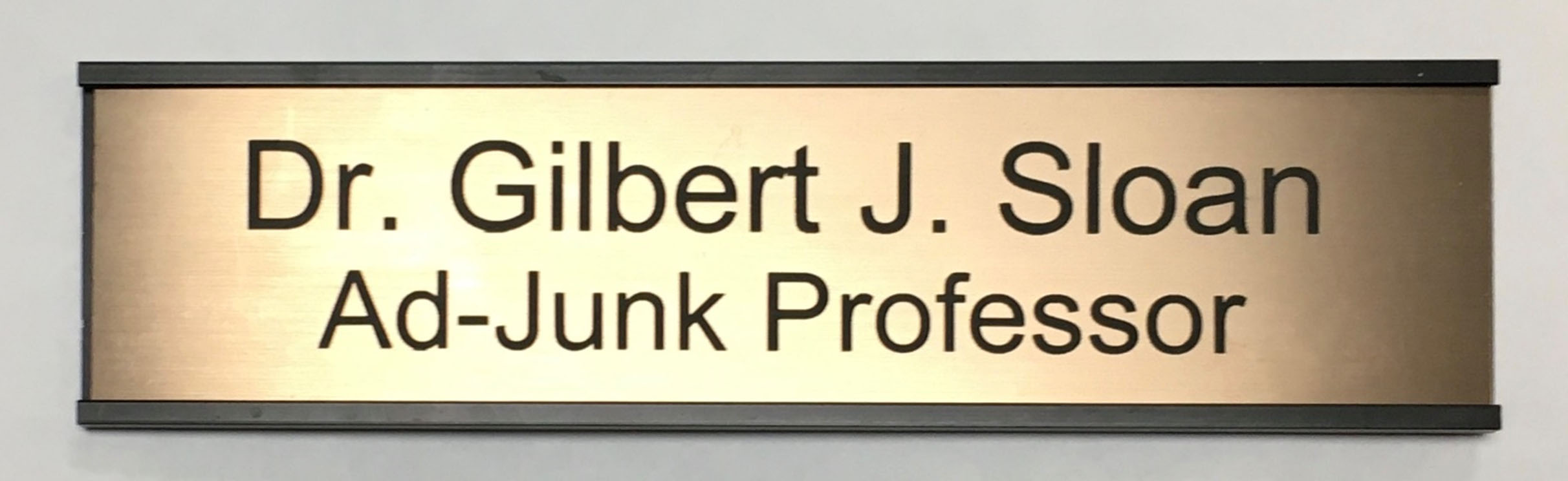 plaque reading: Gil Sloan the Ad-Junk Professor